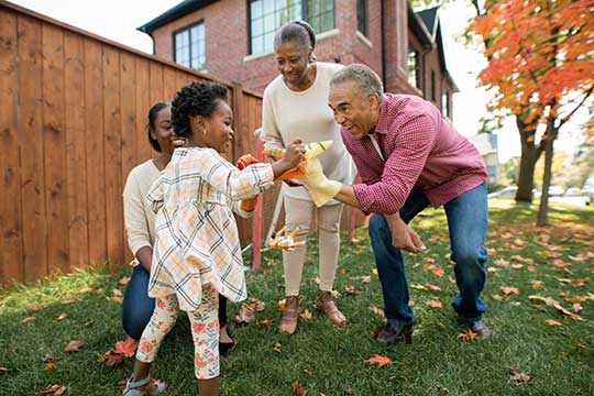 Grandparents playing in the yard with their grandkids