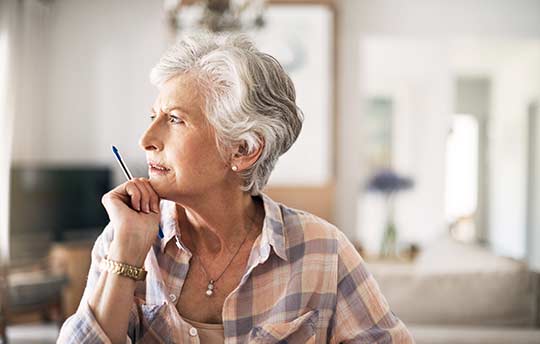 Senior woman wondering about OTC hearing aids.